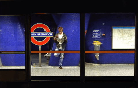London_Underground_waiting_reading_newspaper.png